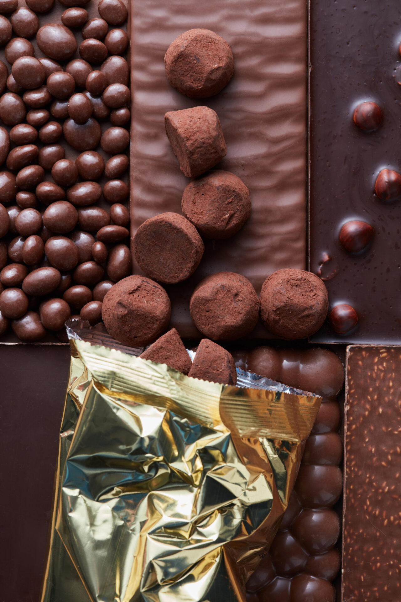 Chocolate Candies Poured On The Background